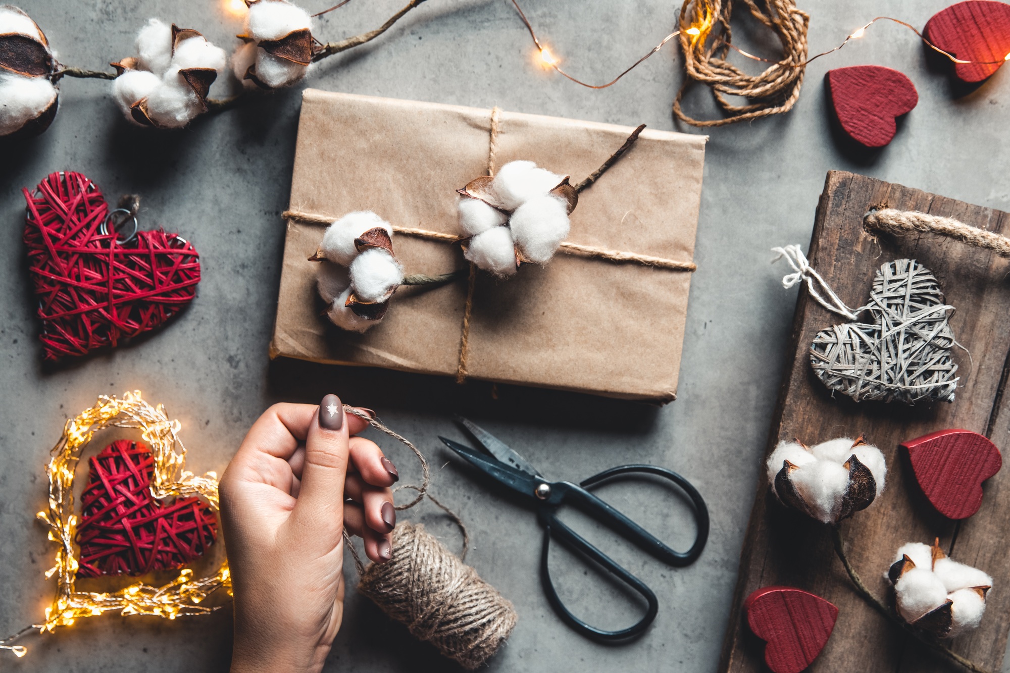 Woman preparing gift for wrapping for Valentine's Day